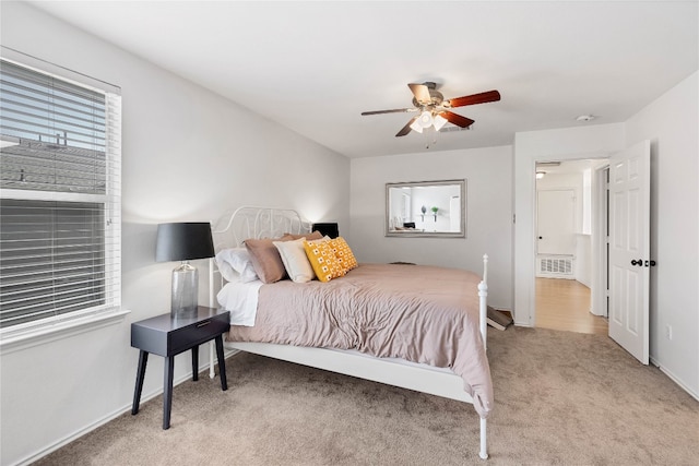 carpeted bedroom featuring visible vents, baseboards, and a ceiling fan