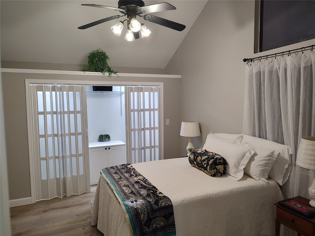 bedroom with multiple windows, light hardwood / wood-style flooring, vaulted ceiling, and ceiling fan