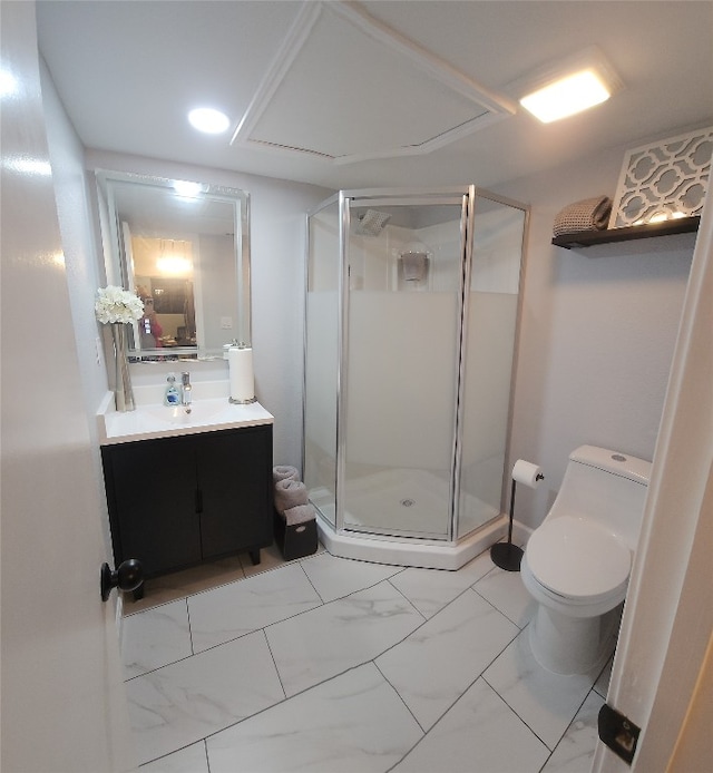 bathroom with vanity, toilet, and a shower with door