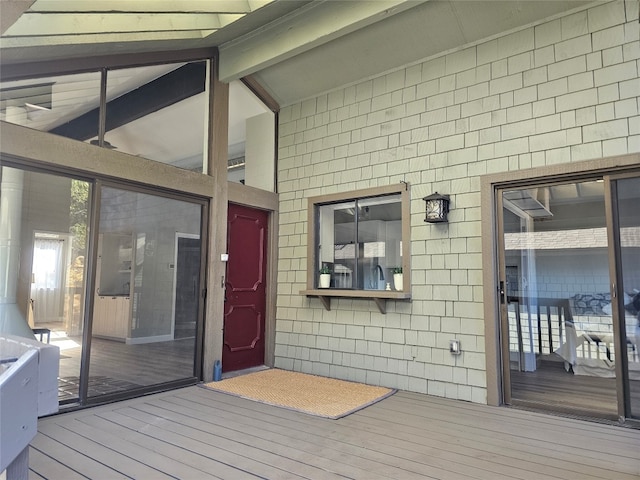 entrance to property featuring a wooden deck