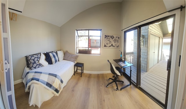 bedroom featuring wood-type flooring and vaulted ceiling