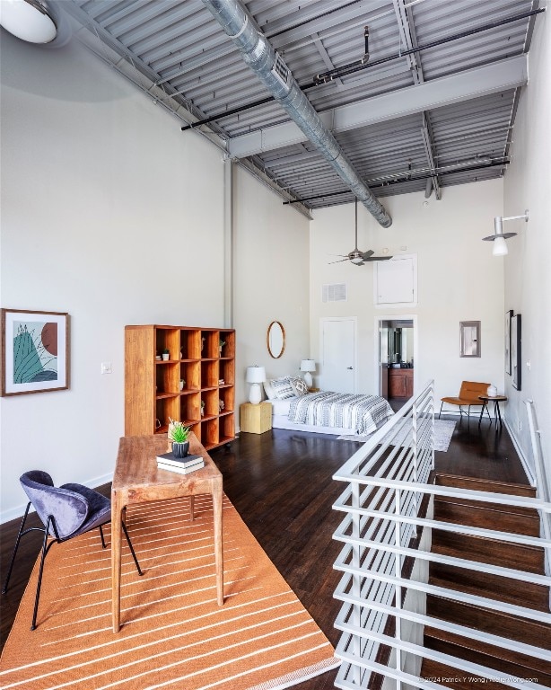 interior space featuring hardwood / wood-style floors, a towering ceiling, and ceiling fan