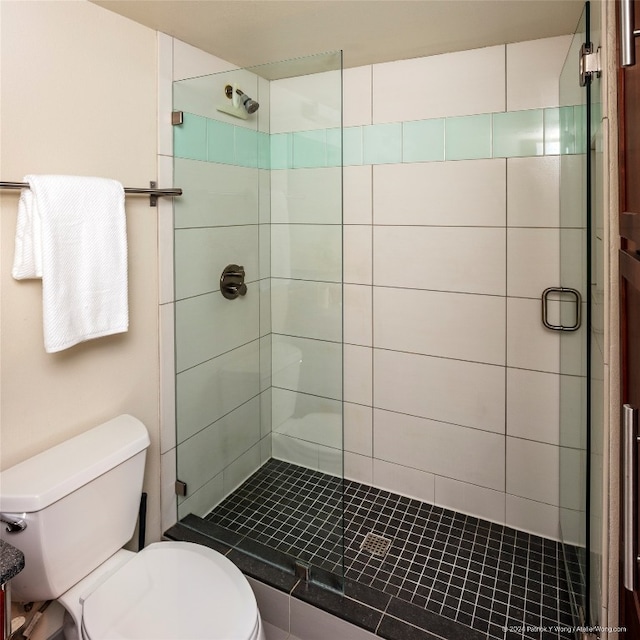 bathroom with walk in shower and toilet