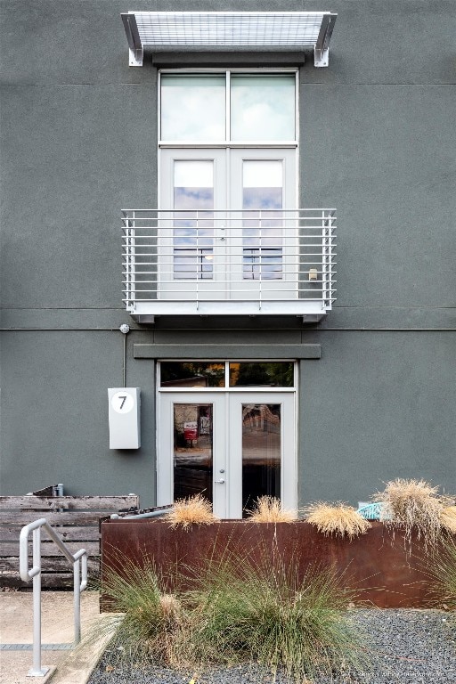 entrance to property with french doors and a balcony