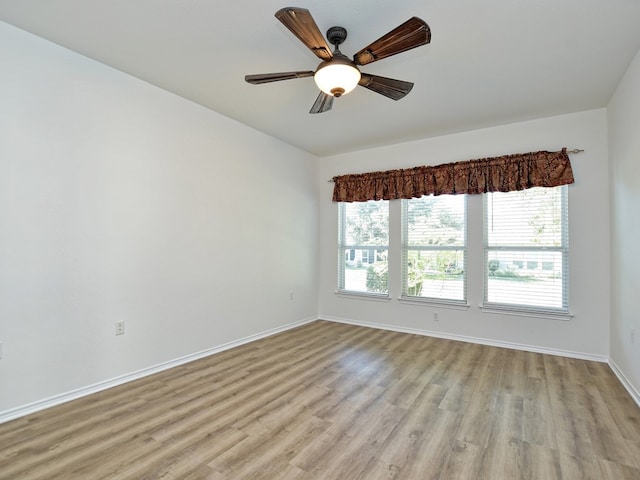 empty room with light hardwood / wood-style floors, ceiling fan, and a healthy amount of sunlight