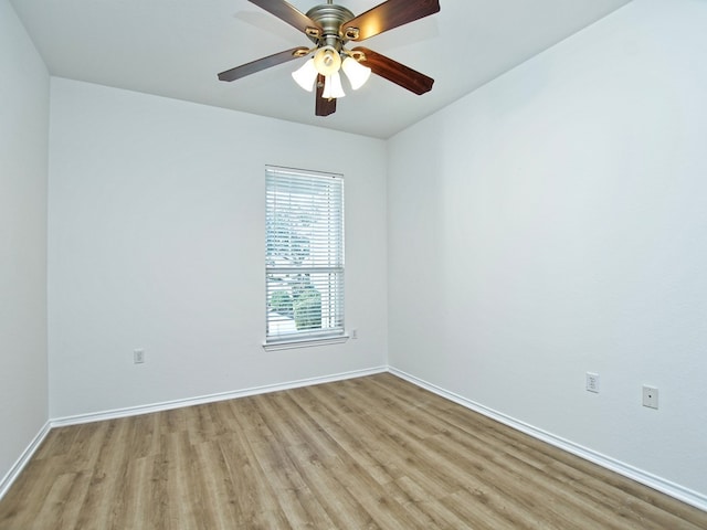 empty room with ceiling fan and light hardwood / wood-style floors