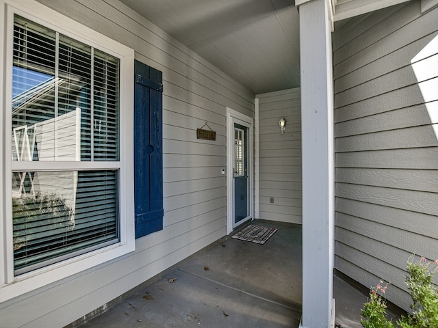 view of exterior entry featuring a porch