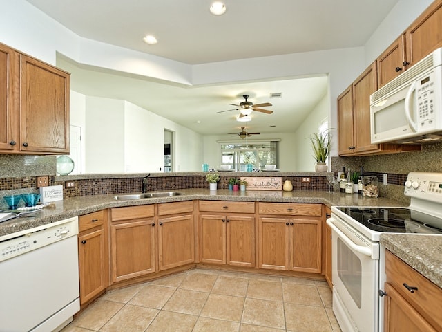 kitchen featuring light tile patterned floors, white appliances, sink, and tasteful backsplash