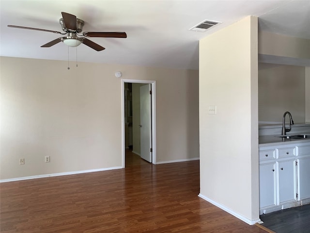 interior space featuring dark wood-type flooring, ceiling fan, and sink