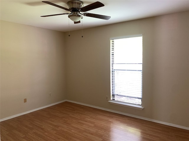 spare room with hardwood / wood-style floors and ceiling fan