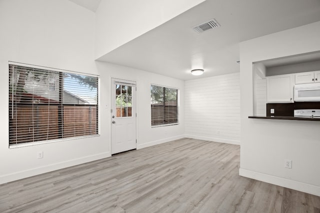 unfurnished living room featuring light wood-type flooring