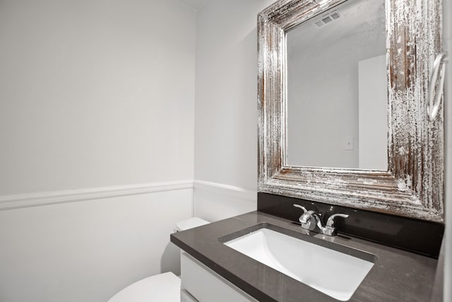 bathroom with toilet and vanity