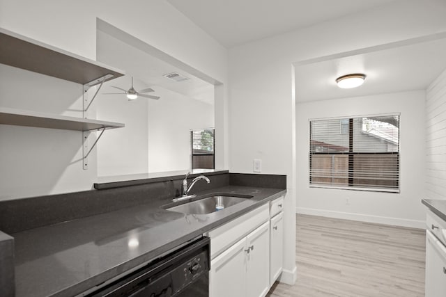 kitchen featuring white cabinets, dishwasher, sink, ceiling fan, and light hardwood / wood-style flooring