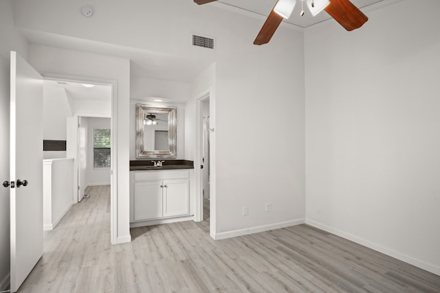 unfurnished room with ornamental molding, light hardwood / wood-style flooring, sink, and ceiling fan