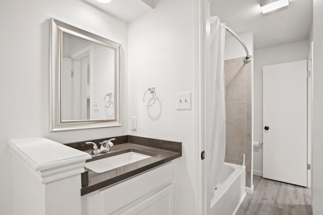 bathroom with shower / bath combo, vanity, and hardwood / wood-style floors