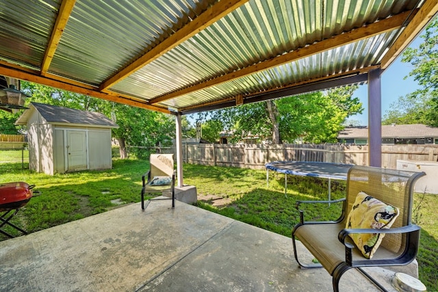 view of patio / terrace featuring a trampoline and a shed