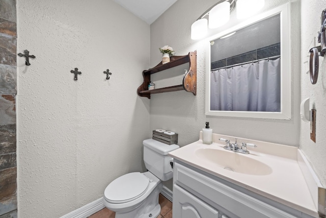 bathroom with curtained shower, tile patterned flooring, vanity, and toilet