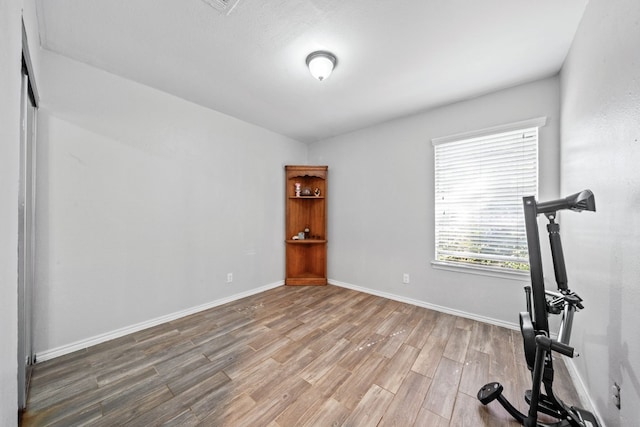 workout room with hardwood / wood-style floors