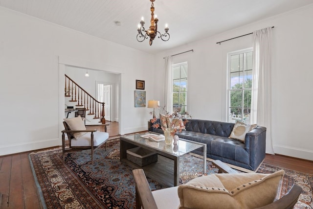 living room with a chandelier, dark hardwood / wood-style flooring, and ornamental molding