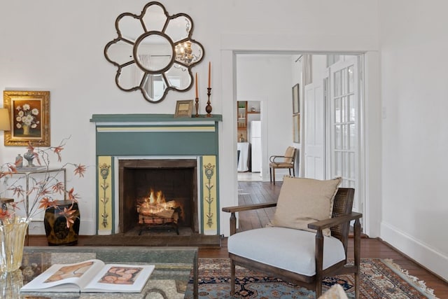 sitting room featuring dark wood-type flooring