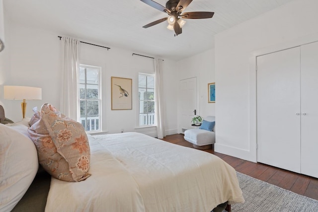 bedroom with dark hardwood / wood-style flooring and ceiling fan