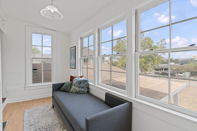 sunroom / solarium featuring plenty of natural light and vaulted ceiling