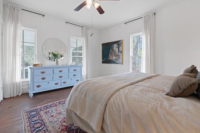 bedroom with dark wood-type flooring and ceiling fan