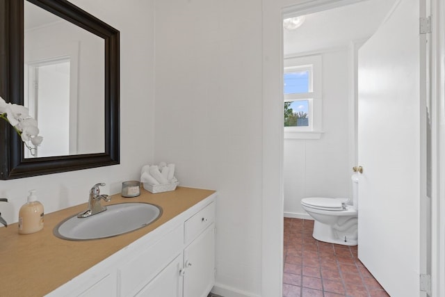 bathroom with tile walls, vanity, and toilet