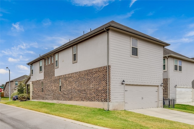 view of side of home featuring a garage and a yard