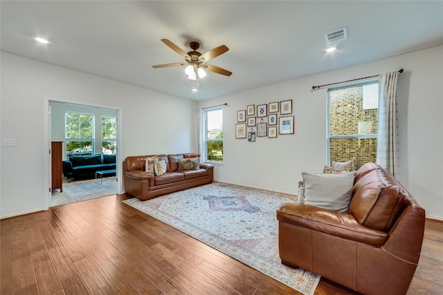 living room with hardwood / wood-style floors and ceiling fan