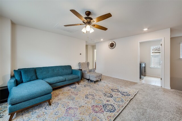 carpeted living room featuring ceiling fan