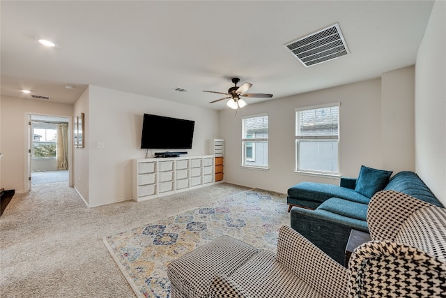 living room with light colored carpet and ceiling fan