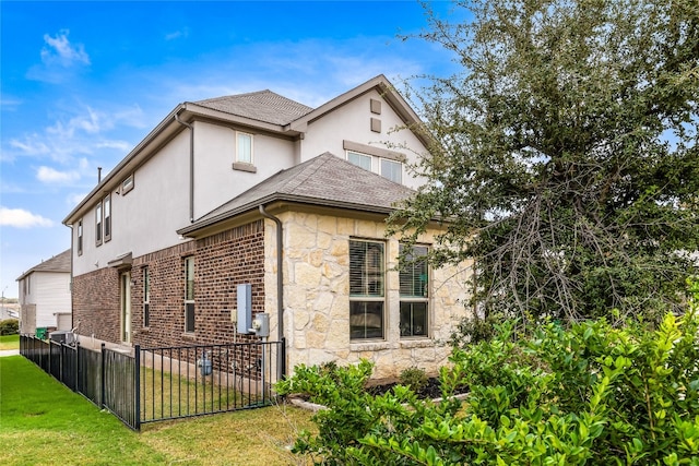 view of side of property with a lawn