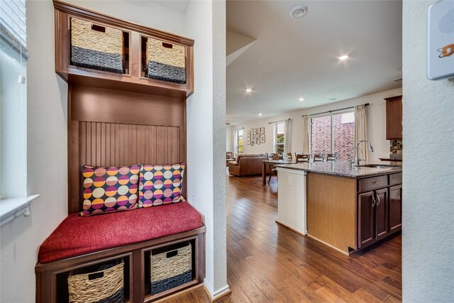 mudroom with sink and dark hardwood / wood-style floors