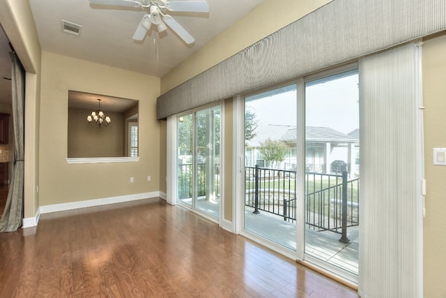 doorway featuring hardwood / wood-style flooring and ceiling fan with notable chandelier