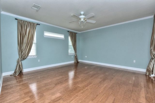 spare room featuring a wealth of natural light, hardwood / wood-style floors, and ceiling fan