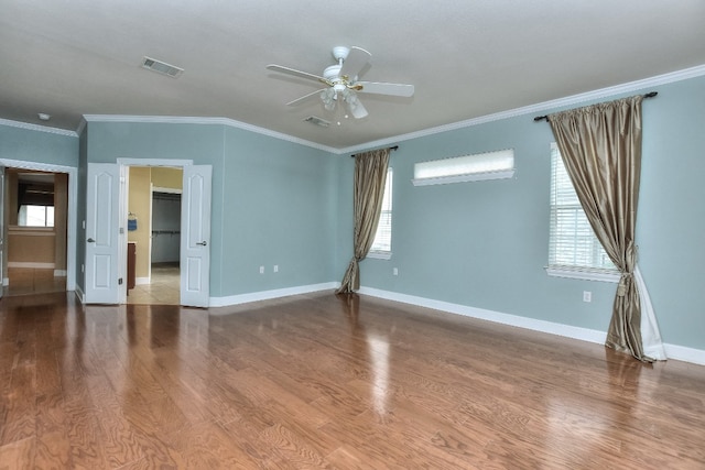 spare room with hardwood / wood-style flooring, ceiling fan, and ornamental molding