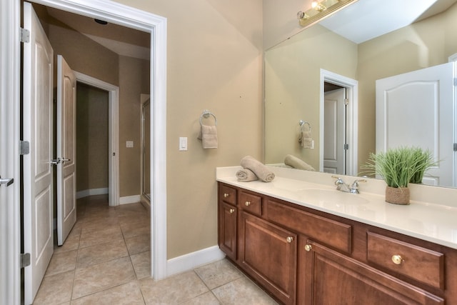 bathroom with walk in shower, tile patterned flooring, and vanity