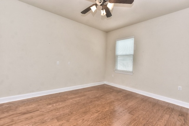 spare room featuring wood-type flooring and ceiling fan