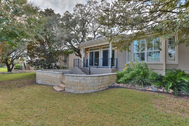 rear view of house with a yard