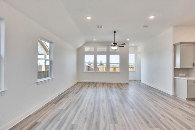unfurnished living room featuring visible vents, baseboards, light wood-type flooring, and ceiling fan