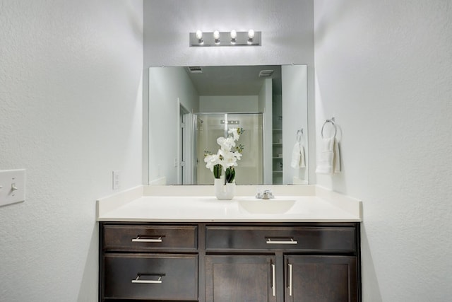 bathroom with vanity and a shower