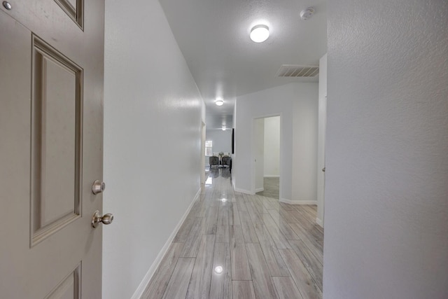 hall with light wood-type flooring