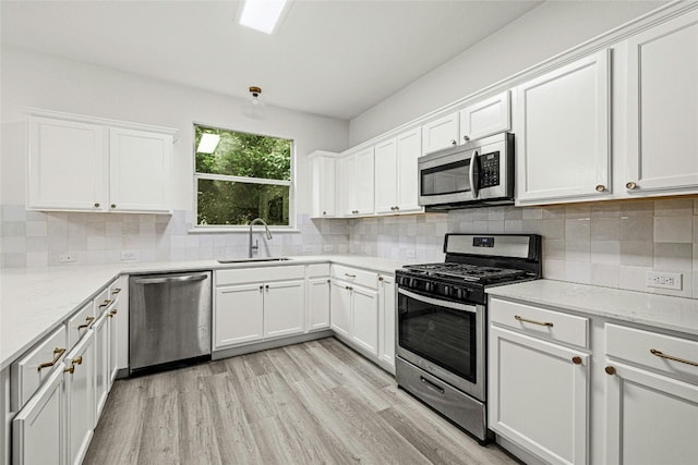 kitchen featuring sink, white cabinets, and stainless steel appliances