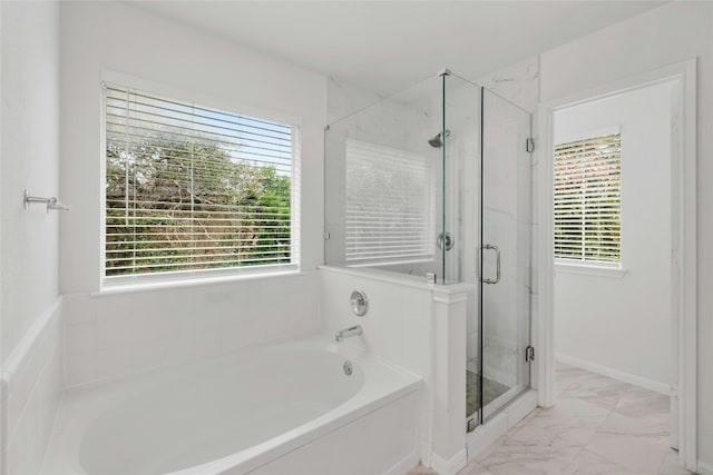 bathroom featuring independent shower and bath