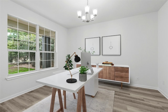 office space featuring an inviting chandelier and light hardwood / wood-style flooring