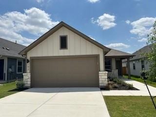 192 Spirit St, Elgin, TX 78621 - ranch-style house with a garage, driveway, and board and batten siding