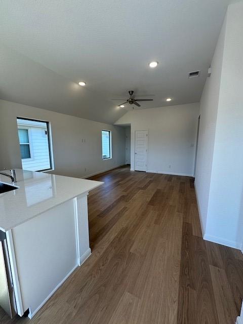 192 Spirit St, Elgin, TX 78621 - unfurnished living room featuring ceiling fan, wood finished floors, and recessed lighting
