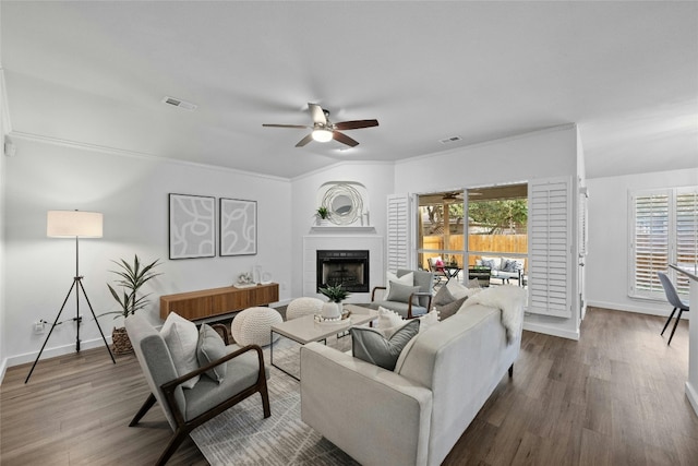 living room featuring crown molding, ceiling fan, and wood-type flooring