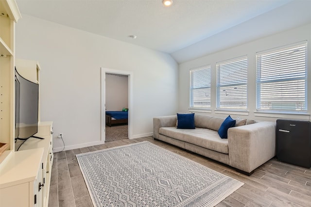 living room featuring lofted ceiling